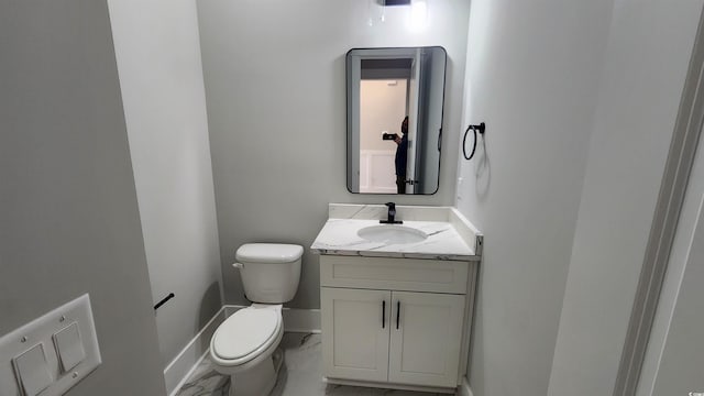 bathroom featuring toilet and vanity