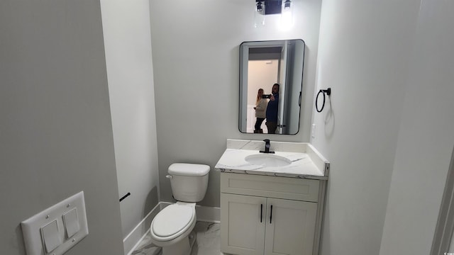 bathroom with toilet and vanity