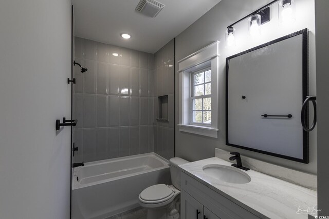 full bathroom with toilet, tiled shower / bath combo, and vanity