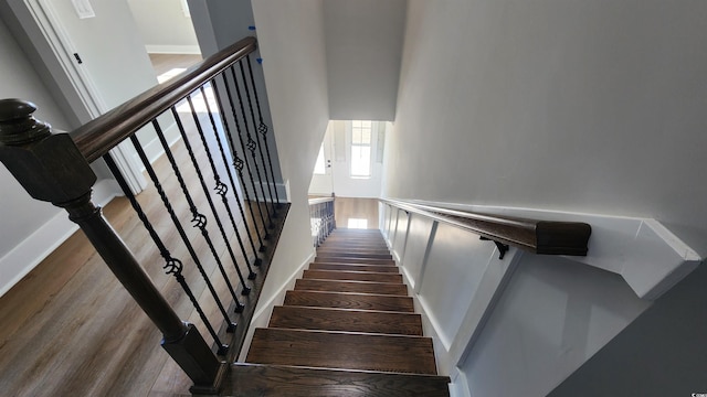 stairs with hardwood / wood-style floors