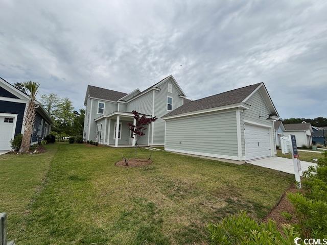 view of front facade with a front yard, driveway, and an attached garage