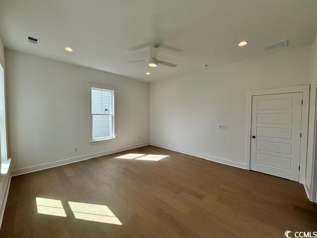 spare room with a ceiling fan, wood finished floors, baseboards, and recessed lighting