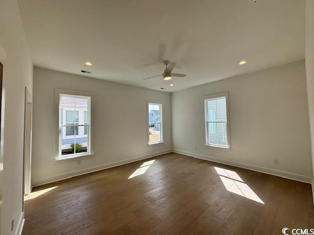 spare room featuring healthy amount of natural light, baseboards, dark wood-style floors, ceiling fan, and recessed lighting