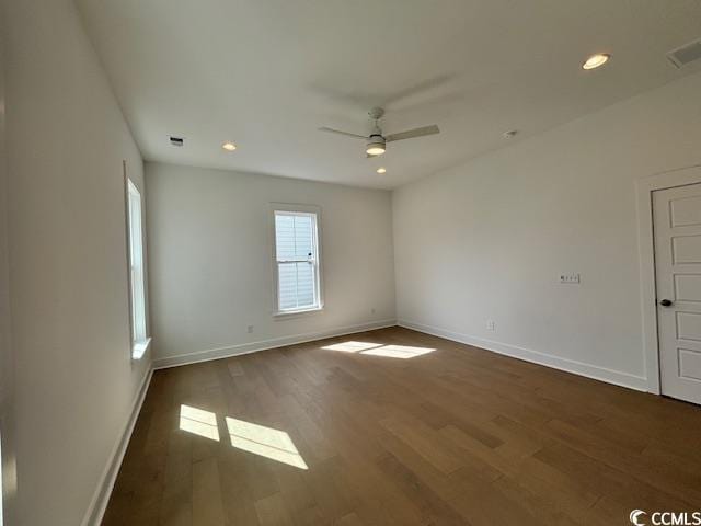 empty room featuring ceiling fan, dark wood-style flooring, baseboards, and recessed lighting