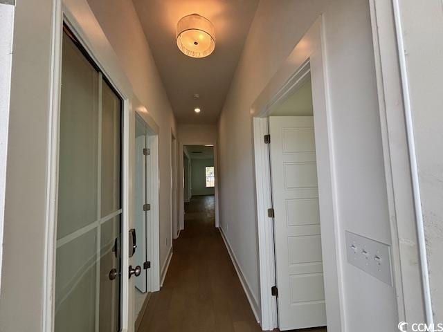 corridor featuring baseboards and recessed lighting