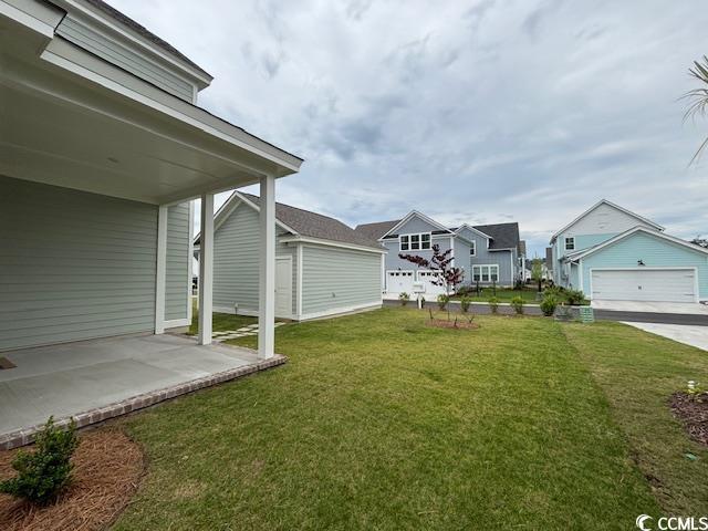 view of grassy yard with a patio area