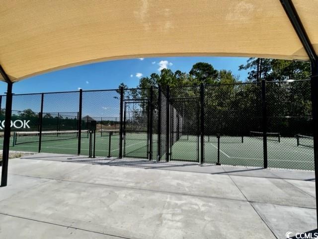 view of tennis court featuring fence