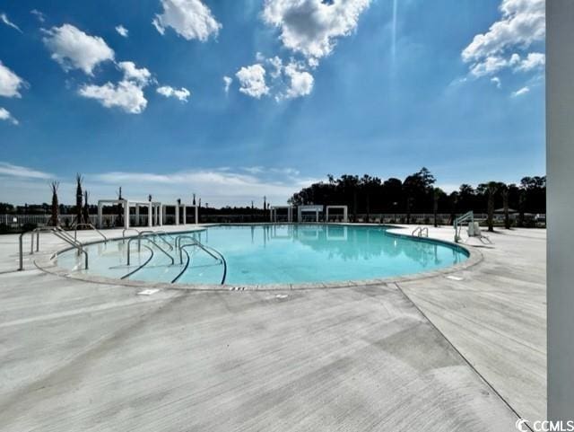 community pool featuring a patio area