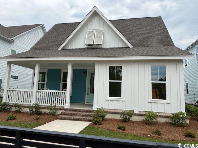 734 Macon Aly, Myrtle Beach, SC 29588 - modern inspired farmhouse with board and batten siding, a porch, and roof with shingles