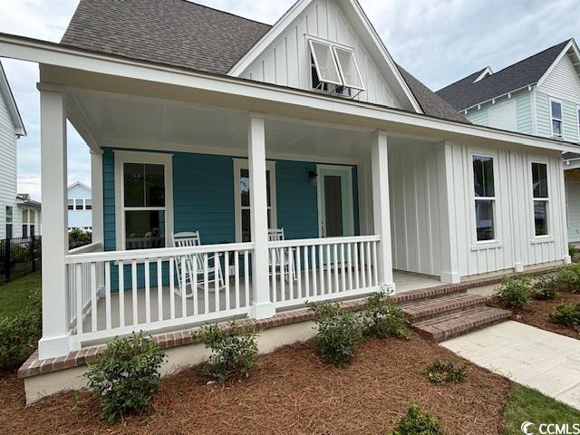 734 Macon Aly, Myrtle Beach, SC 29588 - view of front of home featuring board and batten siding, a porch, and roof with shingles