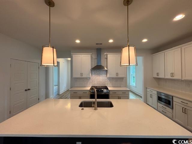 734 Macon Aly, Myrtle Beach, SC 29588 - kitchen with wall chimney exhaust hood, appliances with stainless steel finishes, a sink, backsplash, and recessed lighting
