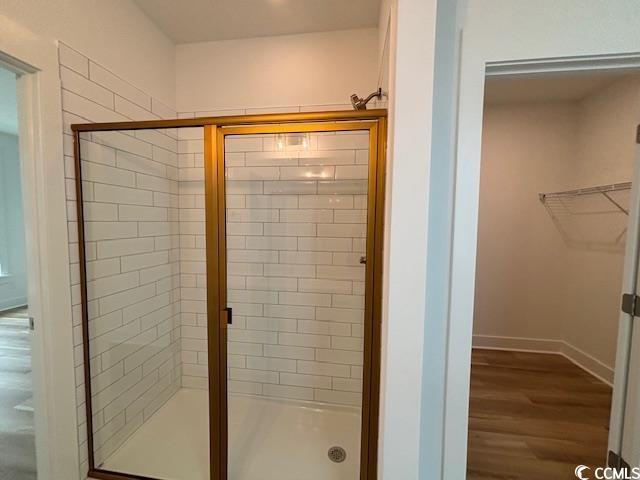 734 Macon Aly, Myrtle Beach, SC 29588 - full bath featuring a stall shower, wood finished floors, a spacious closet, and baseboards