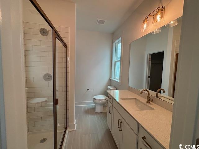 734 Macon Aly, Myrtle Beach, SC 29588 - bathroom featuring baseboards, a shower stall, vanity, and toilet
