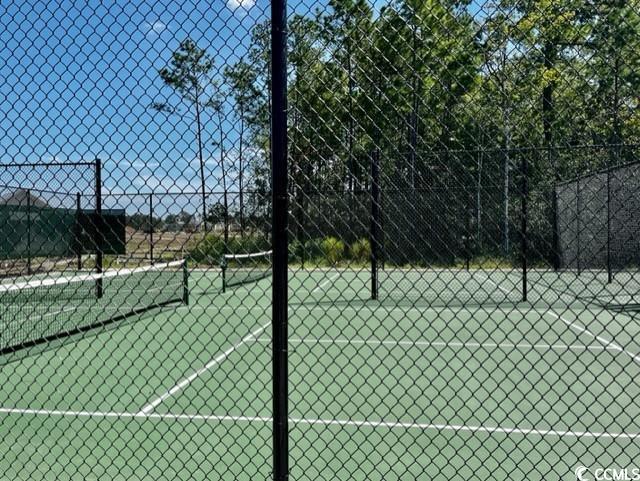 view of sport court featuring fence