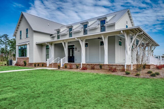 734 Macon Aly, Myrtle Beach, SC 29588 - view of front of property featuring a porch, a front yard, central AC unit, metal roof, and brick siding