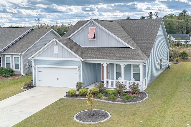 view of front facade with covered porch, a front yard, and a garage