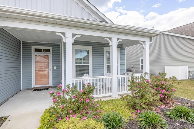 208 Angel Wing Dr, Myrtle Beach, SC 29588 - doorway to property featuring board and batten siding and covered porch