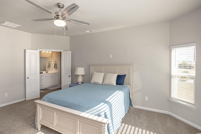 carpeted bedroom featuring ensuite bathroom and ceiling fan