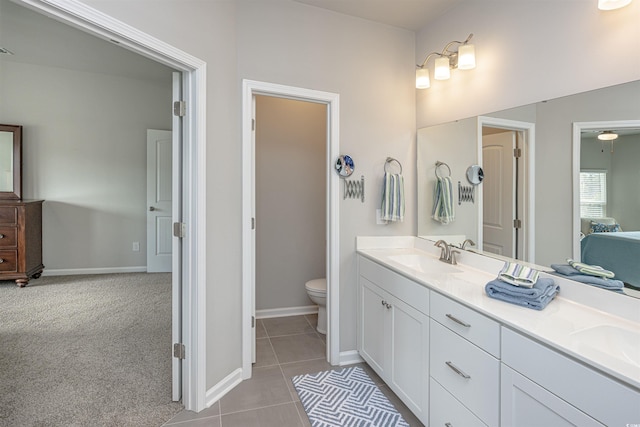 bathroom featuring tile patterned floors, vanity, and toilet