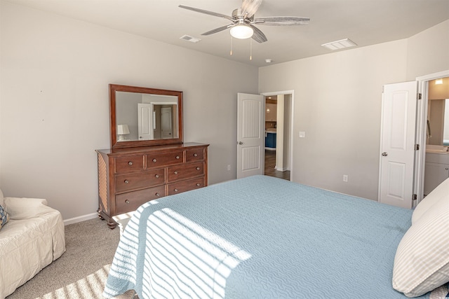 carpeted bedroom featuring ceiling fan and ensuite bath