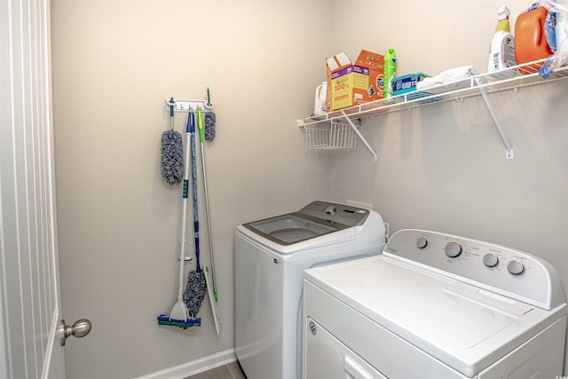 clothes washing area with washing machine and dryer