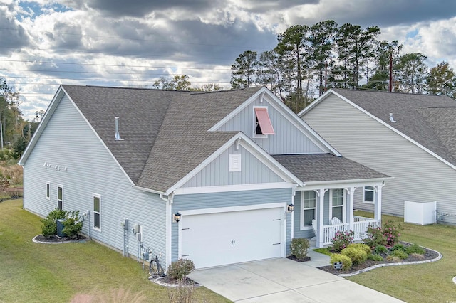 view of front of home with a porch, a garage, and a front lawn