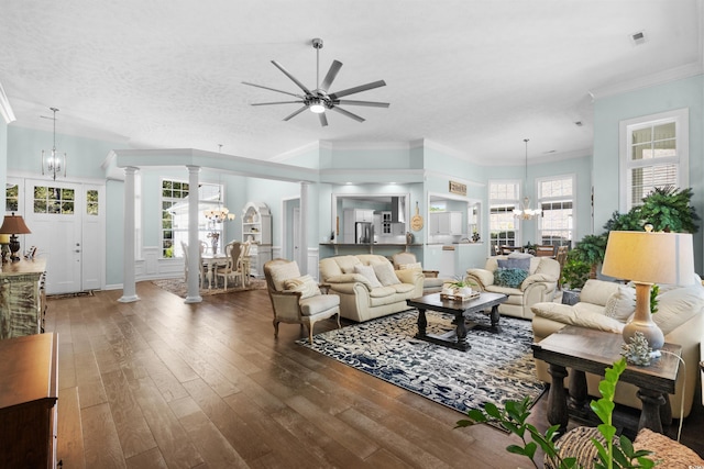 5012 Lindrick Ct, Myrtle Beach, SC 29579 - living room featuring wood-type flooring, a wealth of natural light, ornate columns, and ceiling fan with notable chandelier