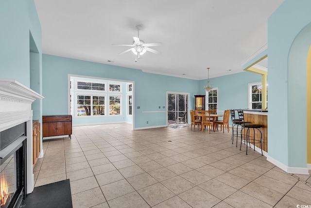 tiled living room with ceiling fan