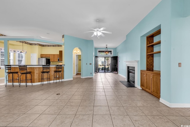 living room featuring ceiling fan and light tile patterned flooring