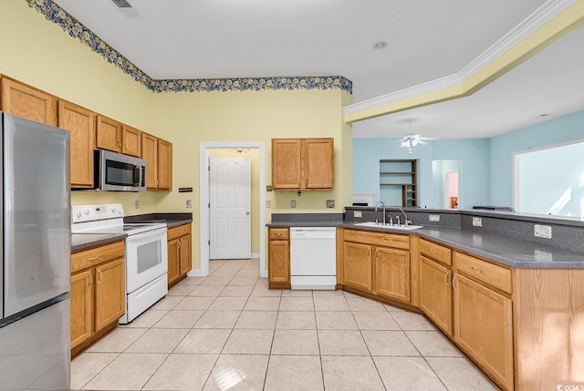 kitchen with kitchen peninsula, stainless steel appliances, ceiling fan, crown molding, and sink