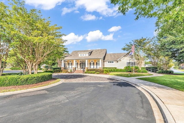 view of front of house featuring a front yard and a porch