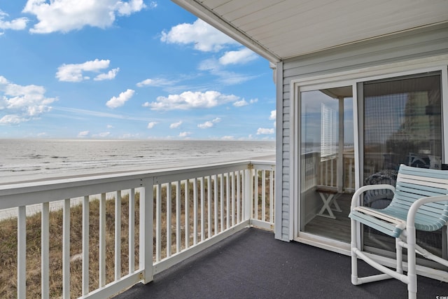 balcony with a water view and a beach view