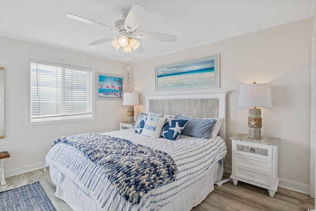 bedroom with ceiling fan and light hardwood / wood-style flooring