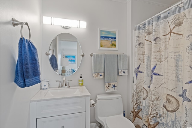 bathroom with walk in shower, crown molding, vanity, and toilet