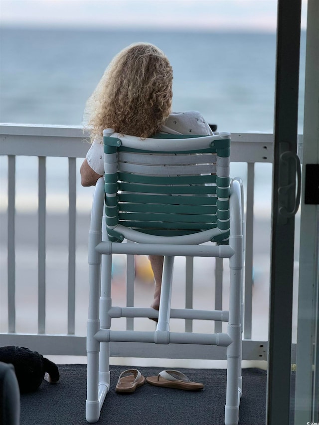 balcony featuring a water view