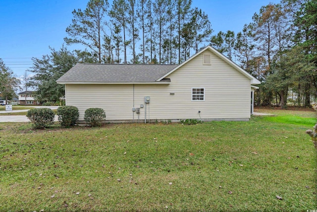 view of side of home with a lawn