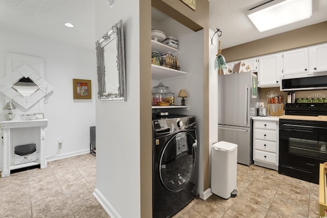 washroom featuring washer / clothes dryer, a fireplace, and a textured ceiling