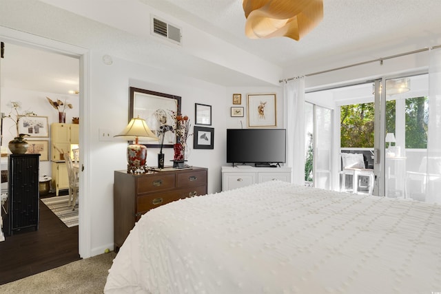 bedroom featuring access to outside and a textured ceiling