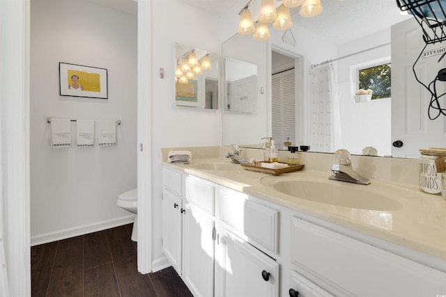 bathroom featuring vanity, hardwood / wood-style floors, and toilet