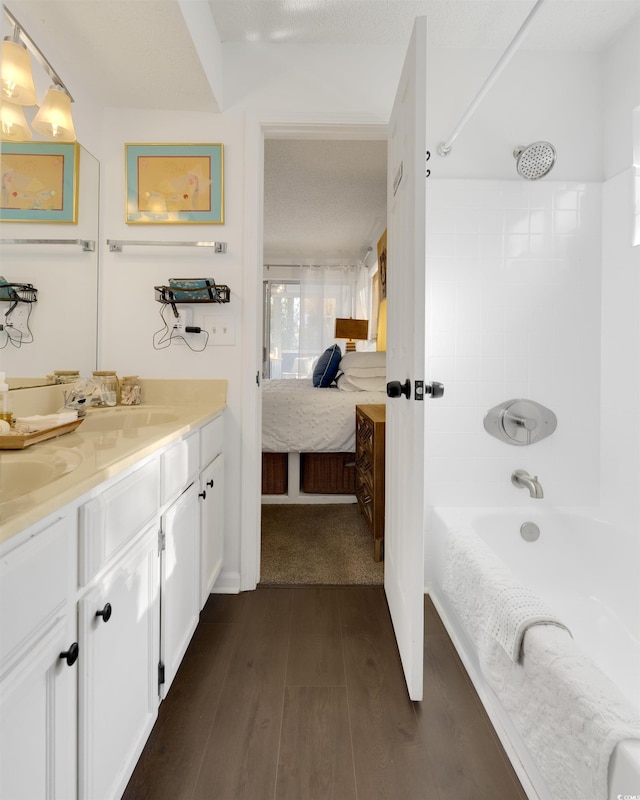 bathroom with vanity, hardwood / wood-style flooring, and bathtub / shower combination