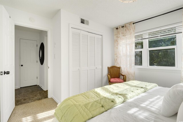 carpeted bedroom with a textured ceiling