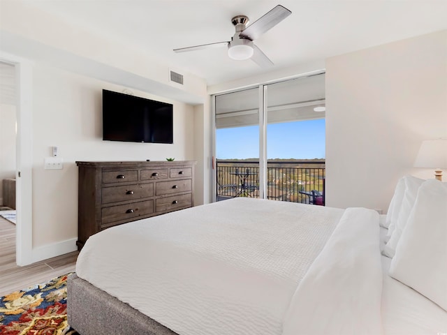 bedroom featuring access to exterior, light wood-type flooring, and ceiling fan