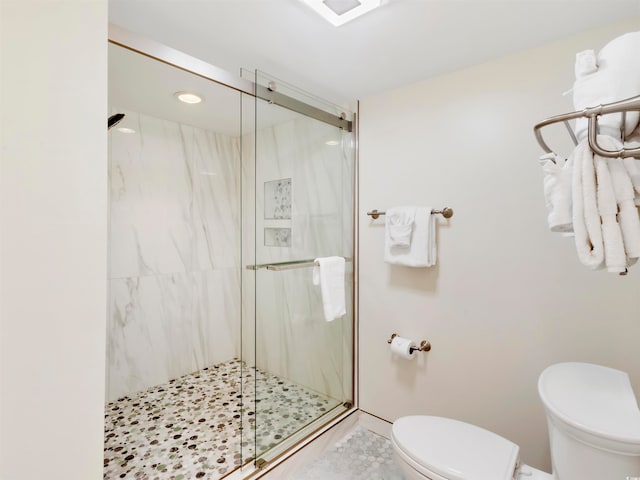 bathroom featuring an enclosed shower and toilet