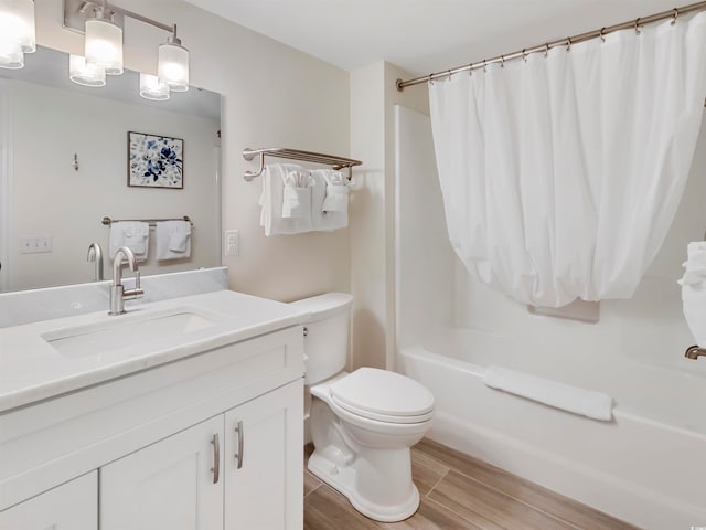 full bathroom featuring vanity, hardwood / wood-style flooring, toilet, and shower / bathtub combination with curtain