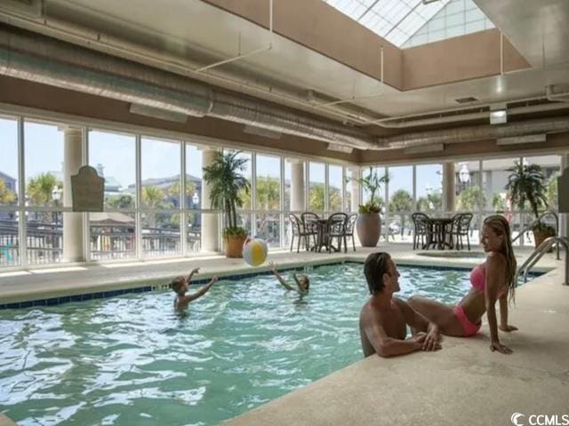 view of swimming pool featuring a skylight