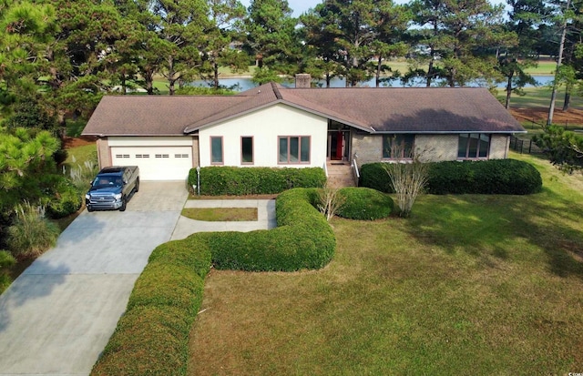 ranch-style home with a water view, a front yard, and a garage