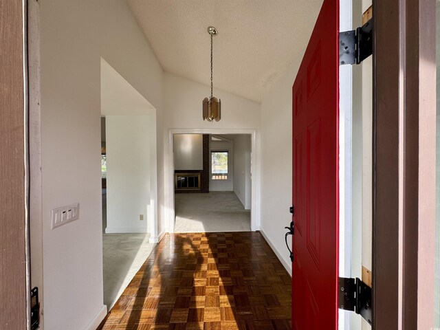 hallway featuring lofted ceiling and a textured ceiling