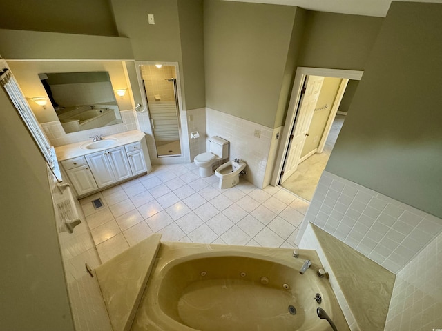 bathroom featuring a bidet, toilet, tile walls, a jetted tub, and a stall shower