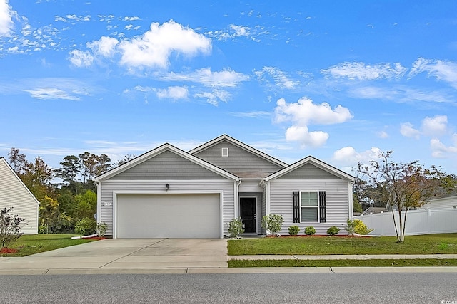 view of front of house featuring a garage and a front lawn