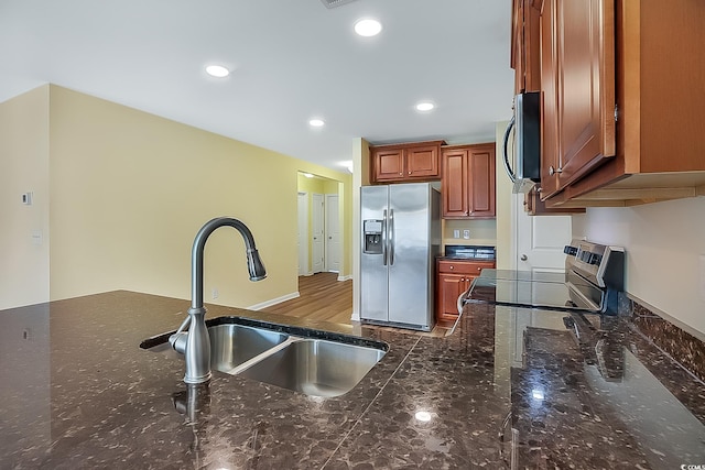 kitchen featuring hardwood / wood-style floors, stainless steel appliances, and sink